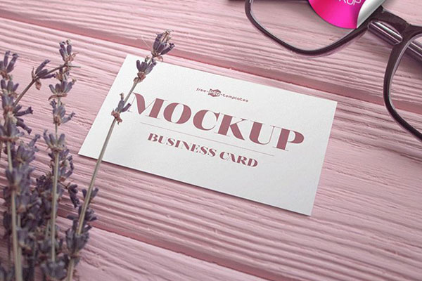 2 Business Card Mockups on Wooden Surface with Glasses and Flower