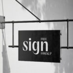 2 Shots of Hanging Sign Mockup on Blank Wall