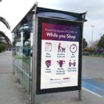 3/4 View Bus Stop Advertising Poster Mockup in Urban Setting