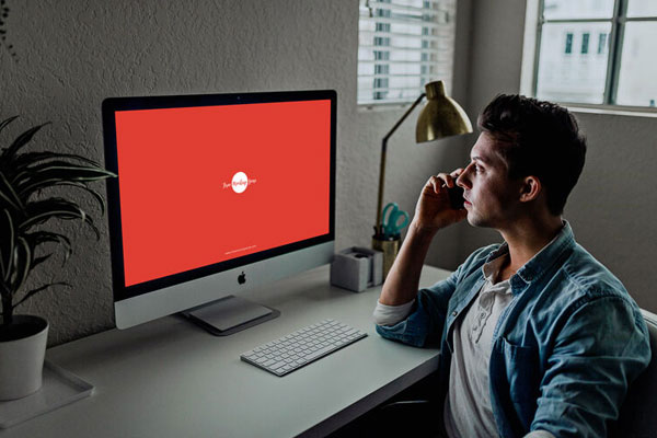 3/4 View Developer Using iMac Mockup Scene