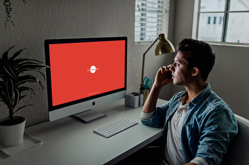 3/4 View Developer Using iMac Mockup Scene