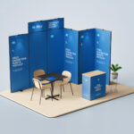 3 Exhibition Booth Mockups Featuring Backdrop, Counter, Desk and Chairs