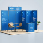 3 Exhibition Booth Mockups Featuring Backdrop, Counter, Desk and Chairs