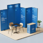 3 Exhibition Booth Mockups Featuring Backdrop, Counter, Desk and Chairs