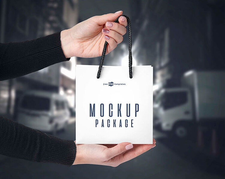 3 Front-View Mockups of a Square Paper Bag in Hand