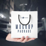 3 Front-View Mockups of a Square Paper Bag in Hand