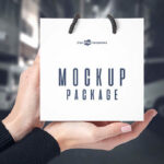 3 Front-View Mockups of a Square Paper Bag in Hand