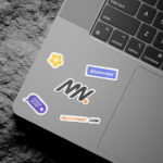 3 Shots of Laptop Sticker Mockup on Rock