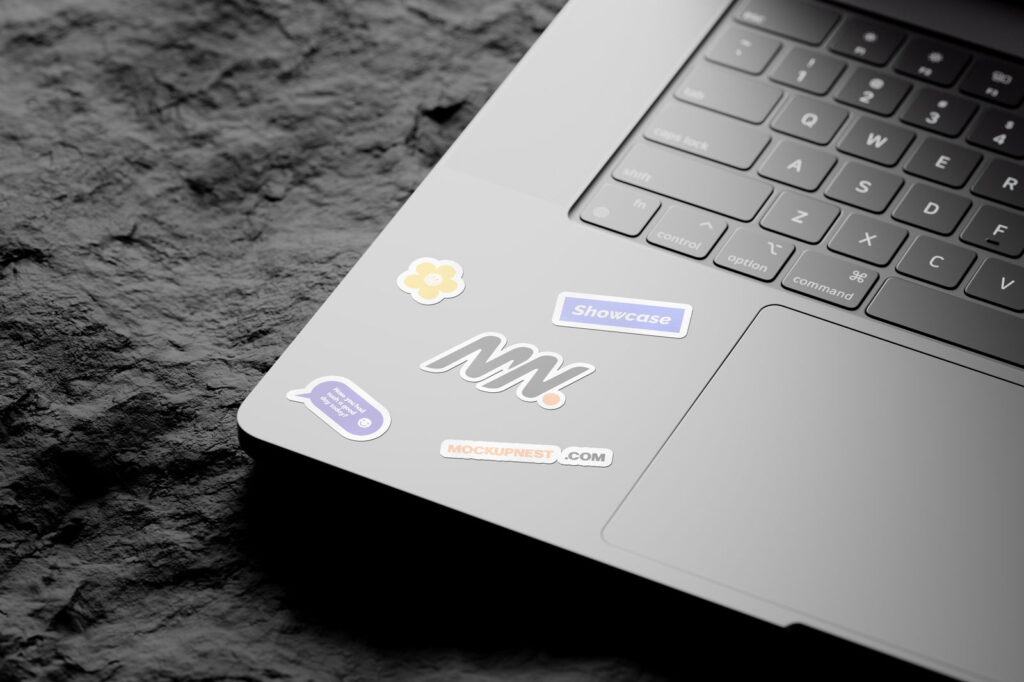 3 Shots of Laptop Sticker Mockup on Rock