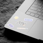 3 Shots of Laptop Sticker Mockup on Rock