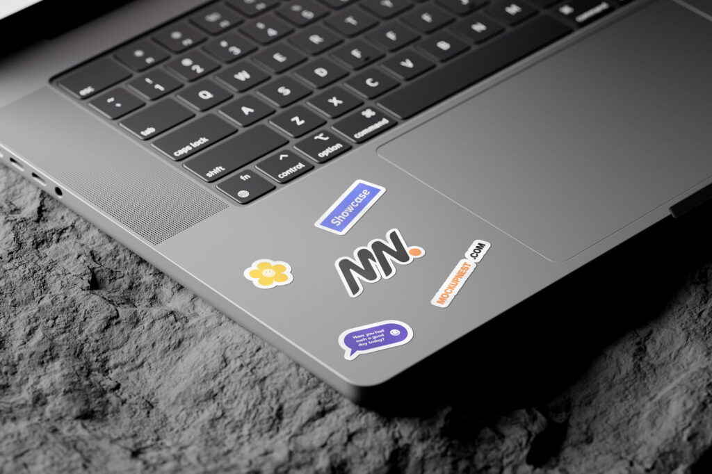 3 Shots of Laptop Sticker Mockup on Rock