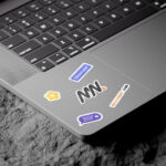 3 Shots of Laptop Sticker Mockup on Rock