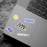 3 Shots of Laptop Sticker Mockup on Rock