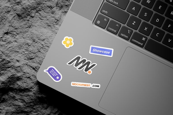 3 Shots of Laptop Sticker Mockup on Rock