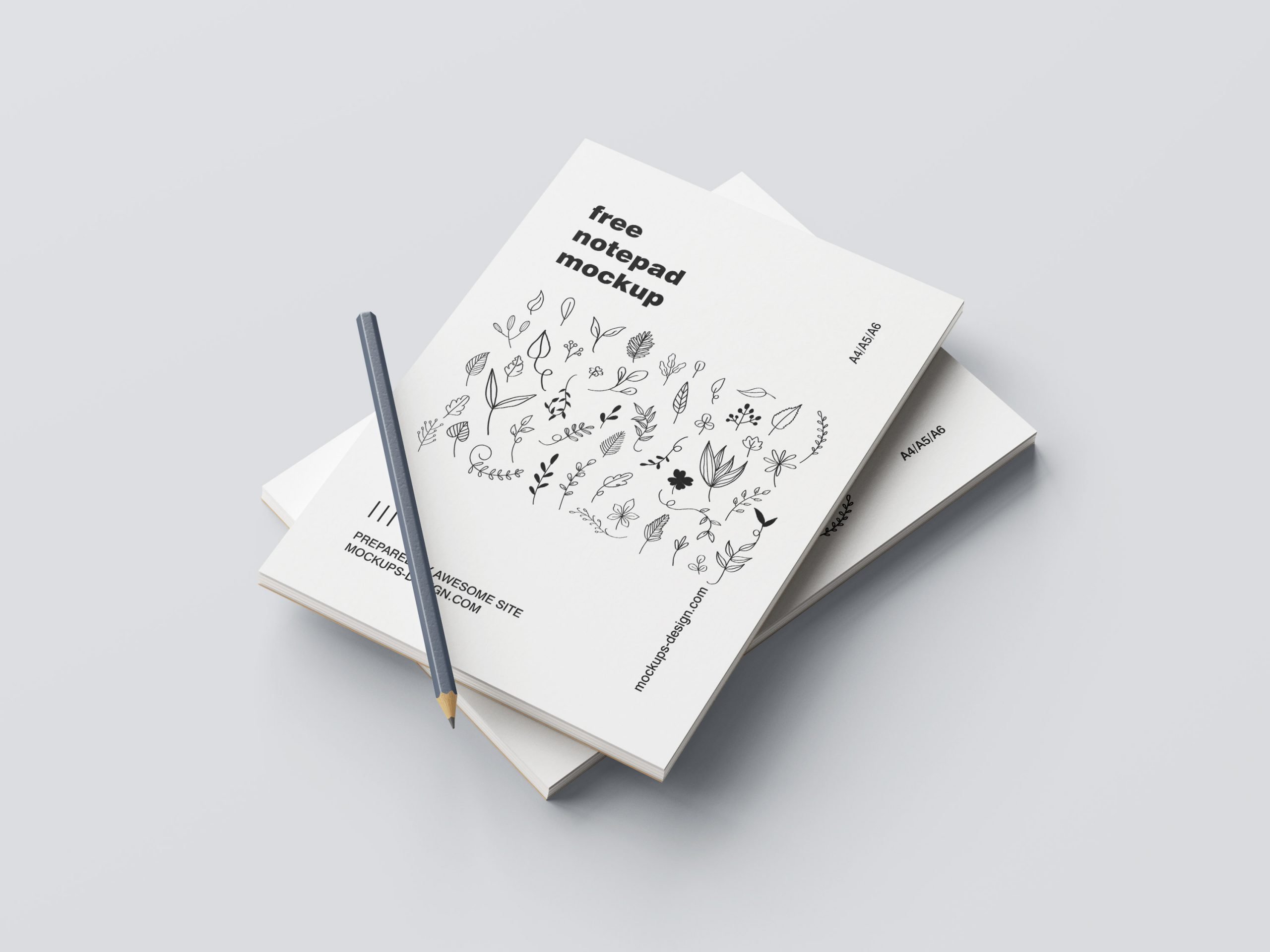 5 Mockups of Notepad with Pencil in Various Perspective Views FREE PSD