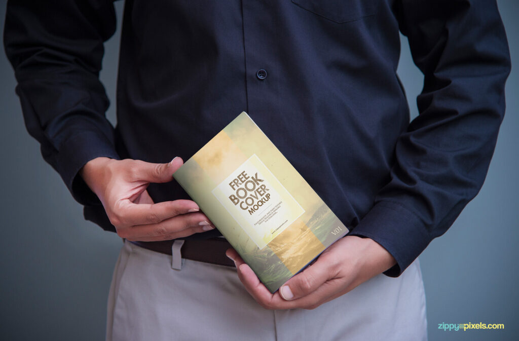 A Book Cover Mockup Held by a Man