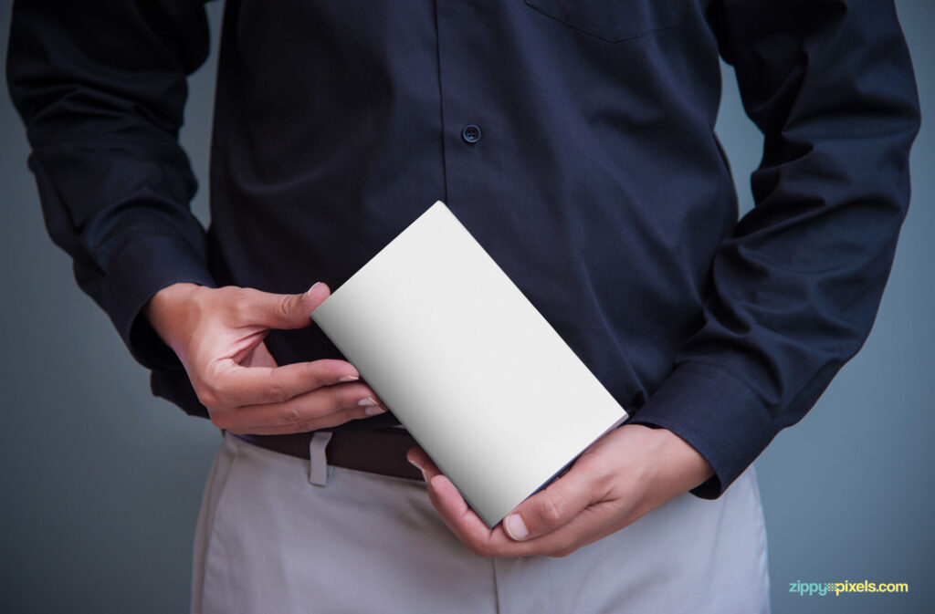 A Book Cover Mockup Held by a Man