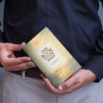A Book Cover Mockup Held by a Man