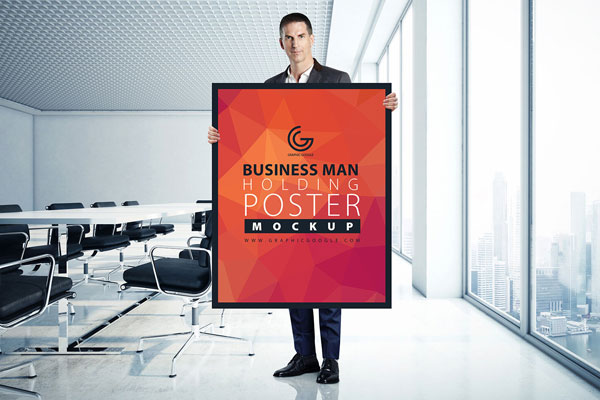 A Man Holding a Poster in an Office Mockup