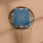 A4 Flyer Mockup in the Overhead View Featuring a Round Side Table