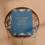 A4 Flyer Mockup in the Overhead View Featuring a Round Side Table