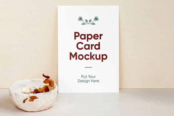 A4 Paper Against Wall Beside a Bowl Containing Dried Leaves Mockup