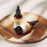 Amber Essential Bottle Mockup in 4 Showcases