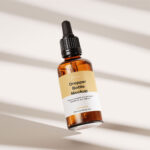 Amber Essential Bottle Mockup in 4 Showcases