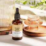 Amber Essential Bottle Mockup in 4 Showcases