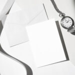 Angled Top View of an Envelope Mockup with Card and Watch