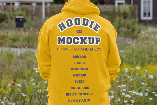 Back View of Man Wearing Oversize Hoodie Mockup in Garden