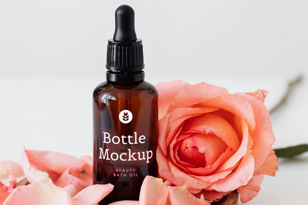 Beauty Bottle Next to a Pink Rose Mockup