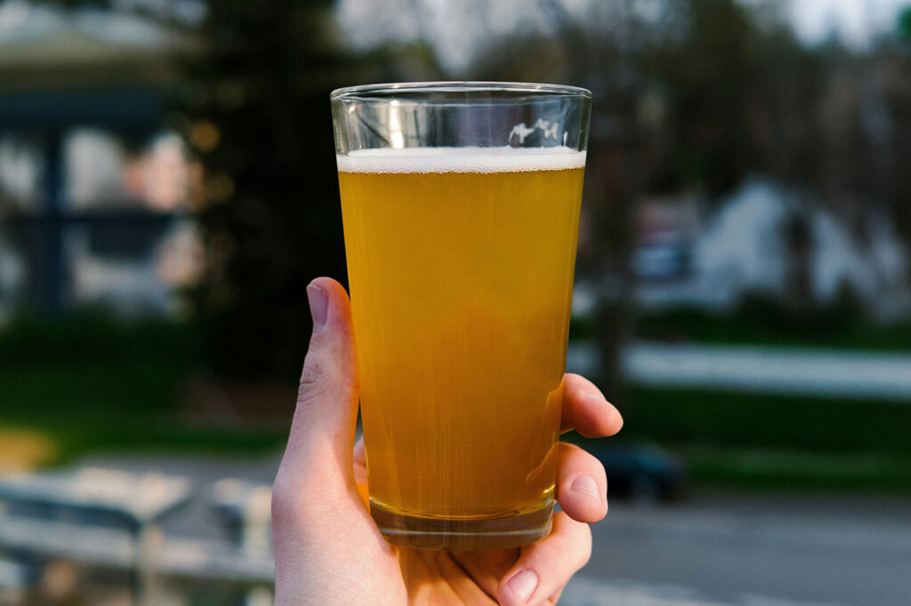 Beer Glass in Hand Mockup