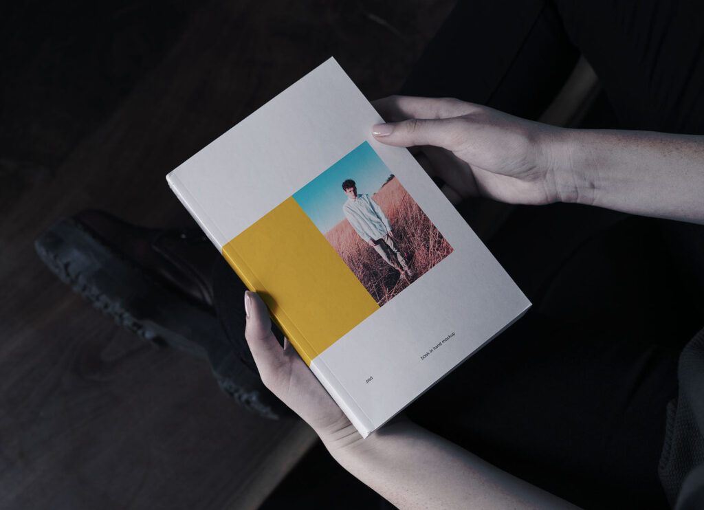 Book in Hand Mockup From Birds Eye View