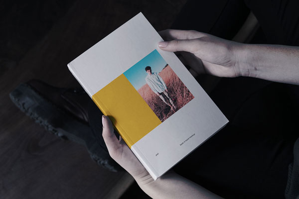 Book in Hand Mockup From Birds Eye View