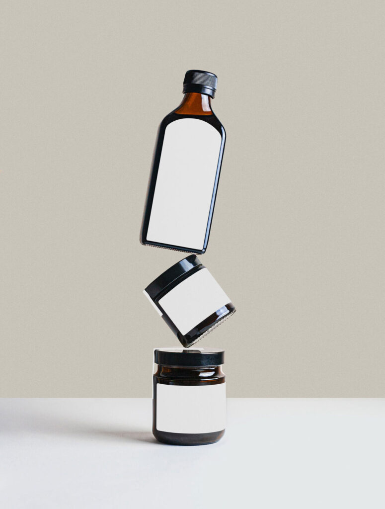Bottle and 2 Jars Floating on Each Other Mockup