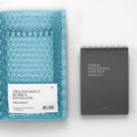 Branding Mockup Featuring Bubble Mailer Envelope and Notebook in Top View