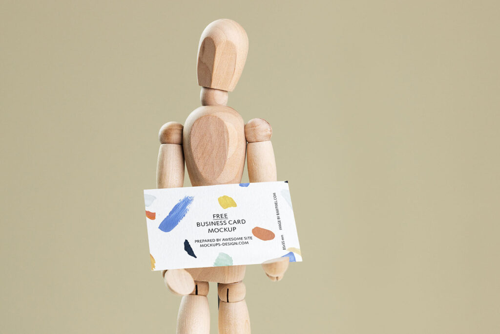 Business Card Held in Hands of a Wooden Manikin Mockup