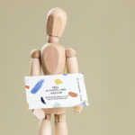 Business Card Held in Hands of a Wooden Manikin Mockup