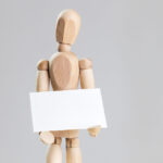 Business Card Held in Hands of a Wooden Manikin Mockup