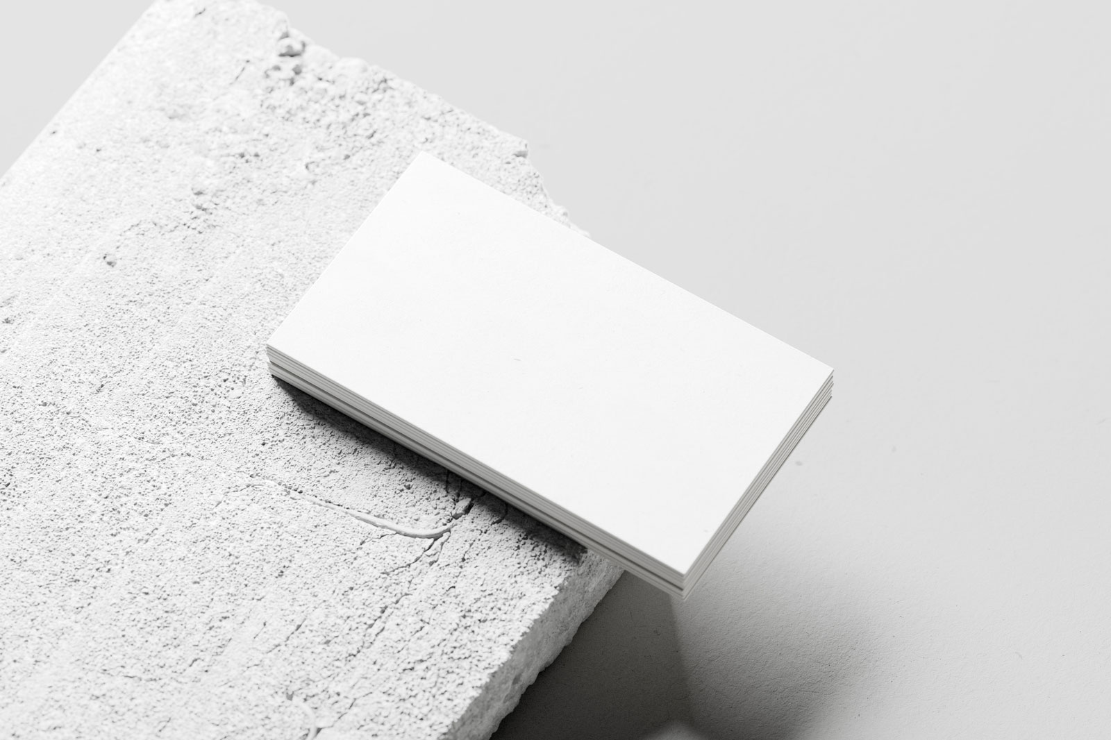 Free Business Card Mockup Stacked on Concrete PSD Template