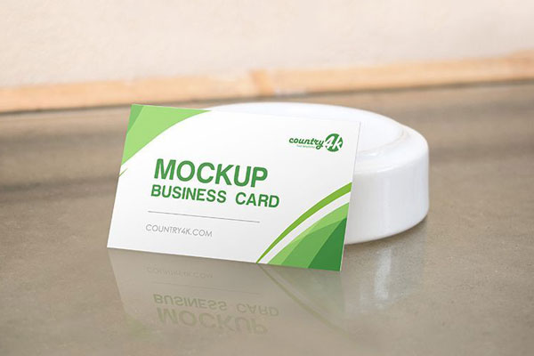 Business Card on the Table in the Half-Side View Mockup