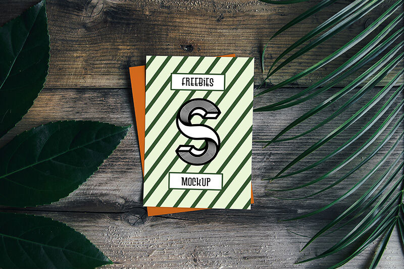 Card Mockup with Plant and Wooden Background