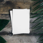 Card Mockup with Plant and Wooden Background