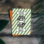 Card Mockup with Plant and Wooden Background