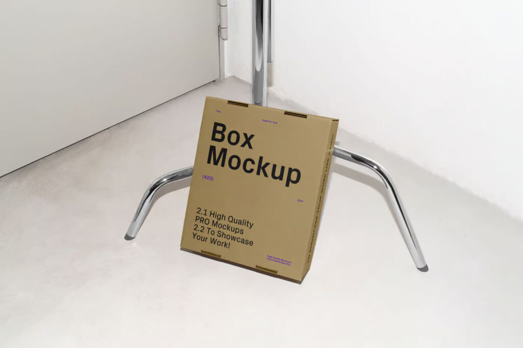 Cardboard Box Leaning Against Tripod Mockup