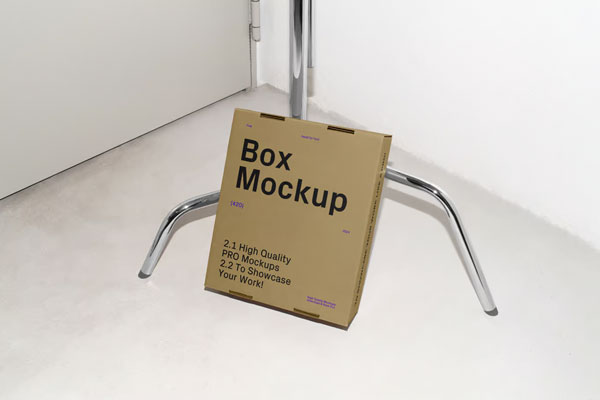 Cardboard Box Leaning Against Tripod Mockup