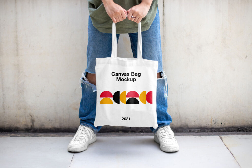Casual Outdoor Man Holding Canvas Bag Mockup from Front View