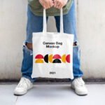 Casual Outdoor Man Holding Canvas Bag Mockup from Front View