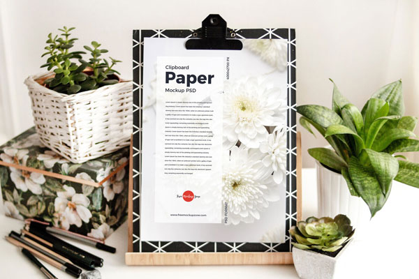 Clipboard with Paper in Wooden Stand Mockup Featuring Plant Pots